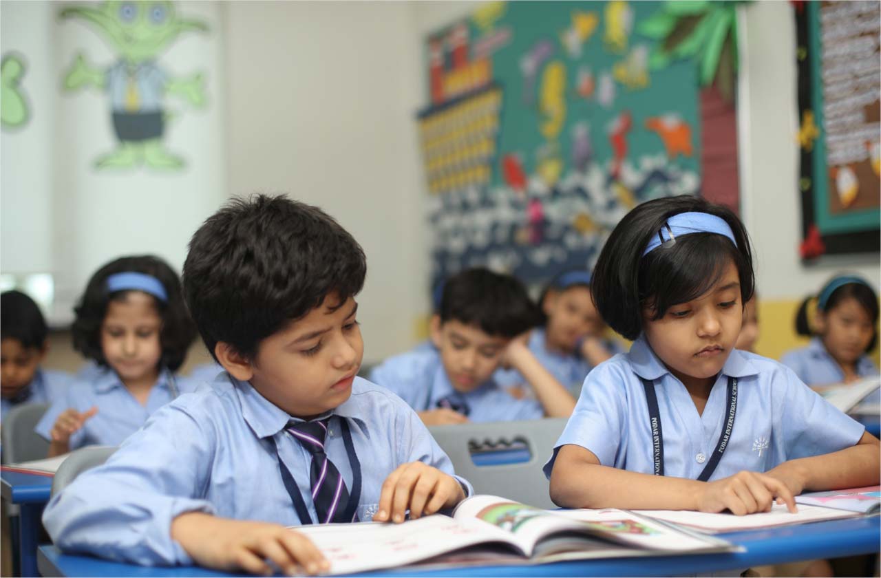 Parent helping child read Hindi book at home