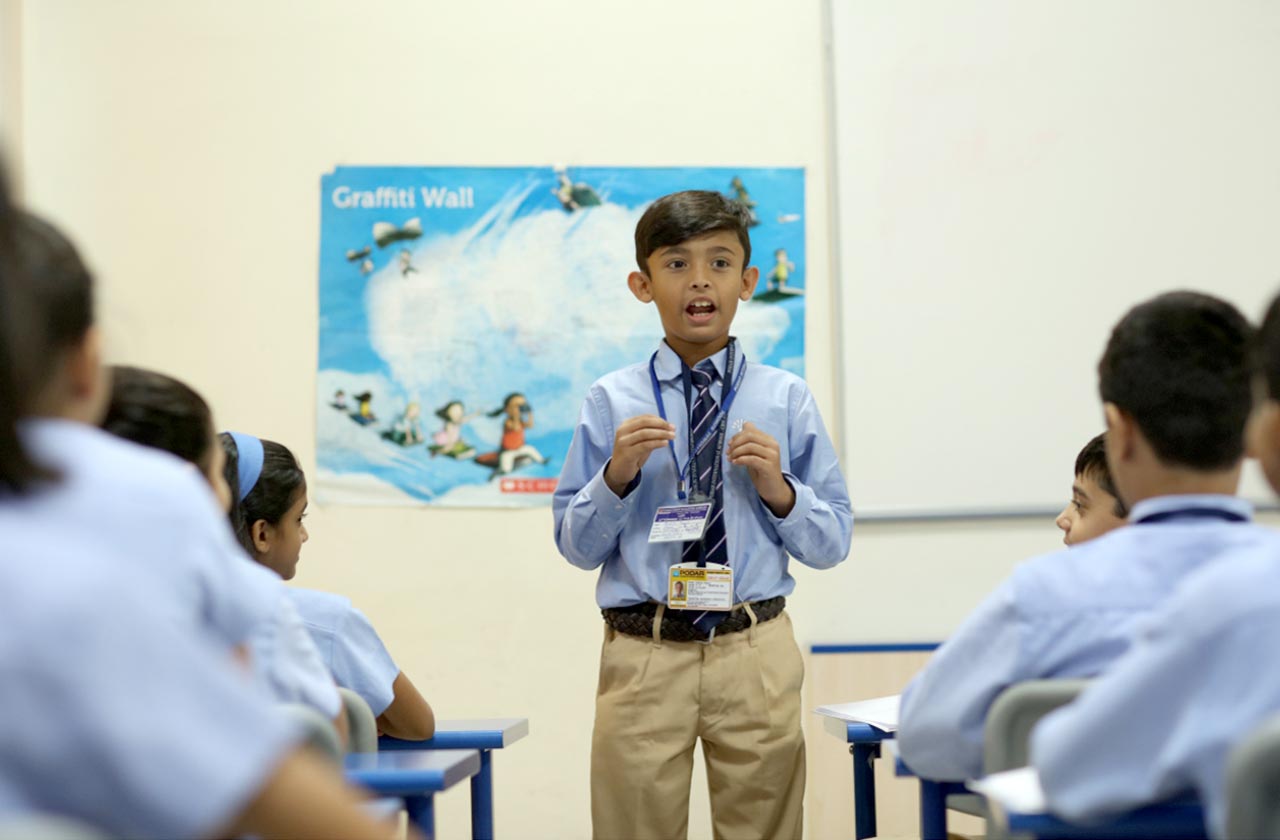 A shy student confidently participating in class and a supportive teacher encourages open communication and self-expression.